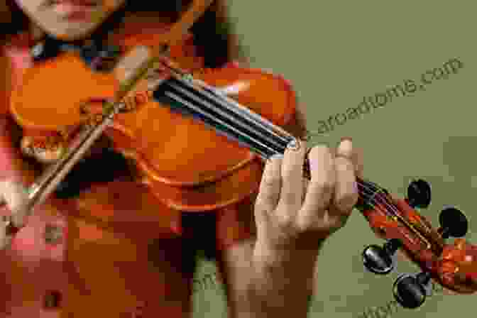 A Close Up Of A Person Playing The Viola 101 Hit Songs For Viola